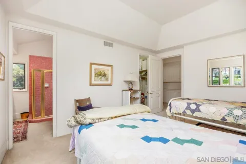 a bedroom with a bed and dresser