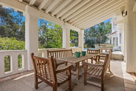a view of a chairs and table in patio with a backyard