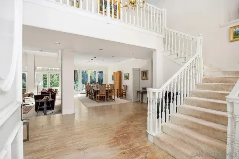 a view of a livingroom with furniture and floor to ceiling window
