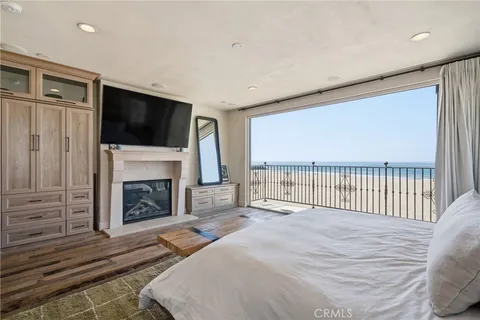 a spacious bedroom with a bed and a flat screen tv