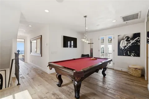 a room with furniture pool table and flat screen tv