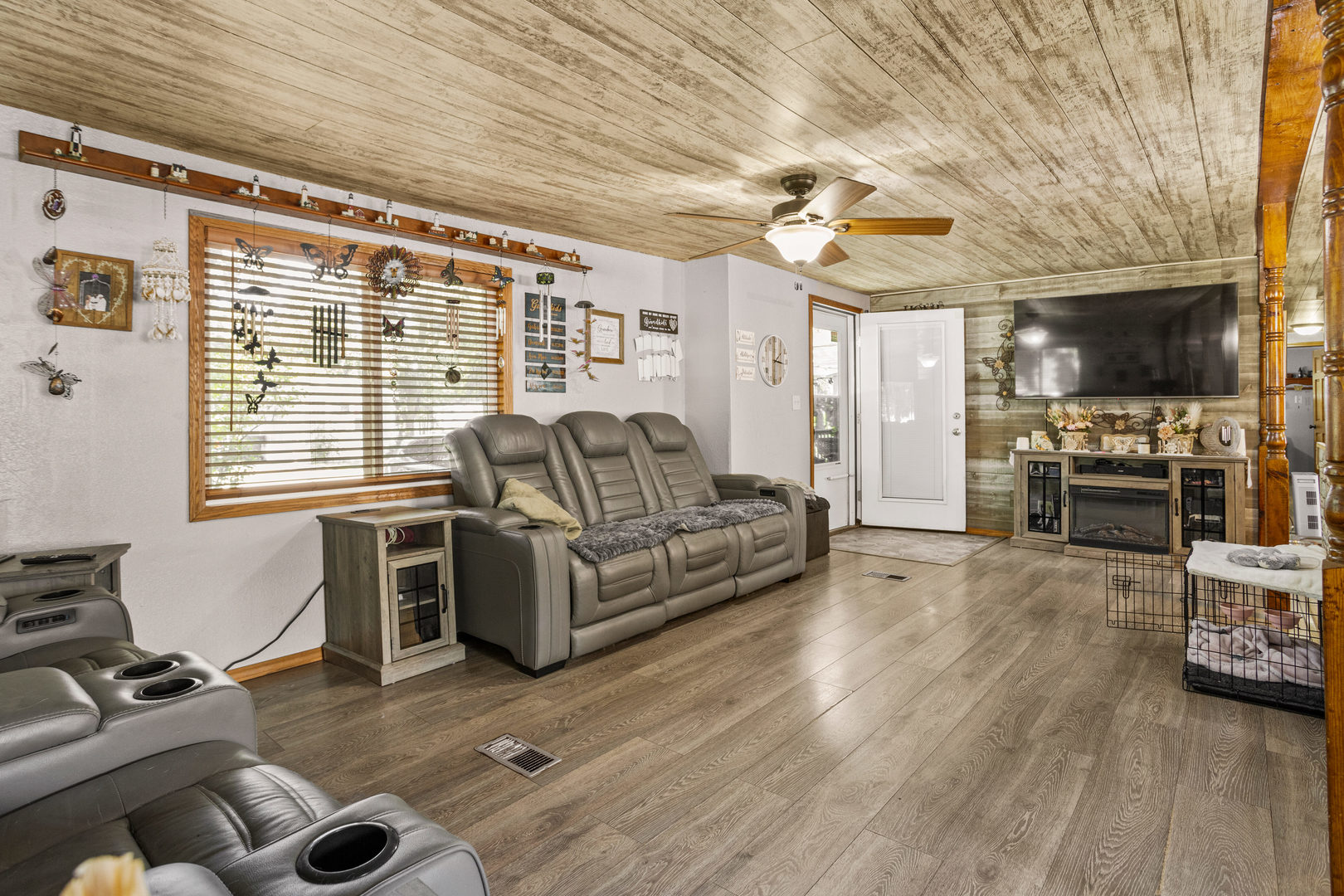 250 Troy Lane Decatur, IL 62526 - Photo 7 of 24 a living room with furniture a flat screen tv and a fireplace