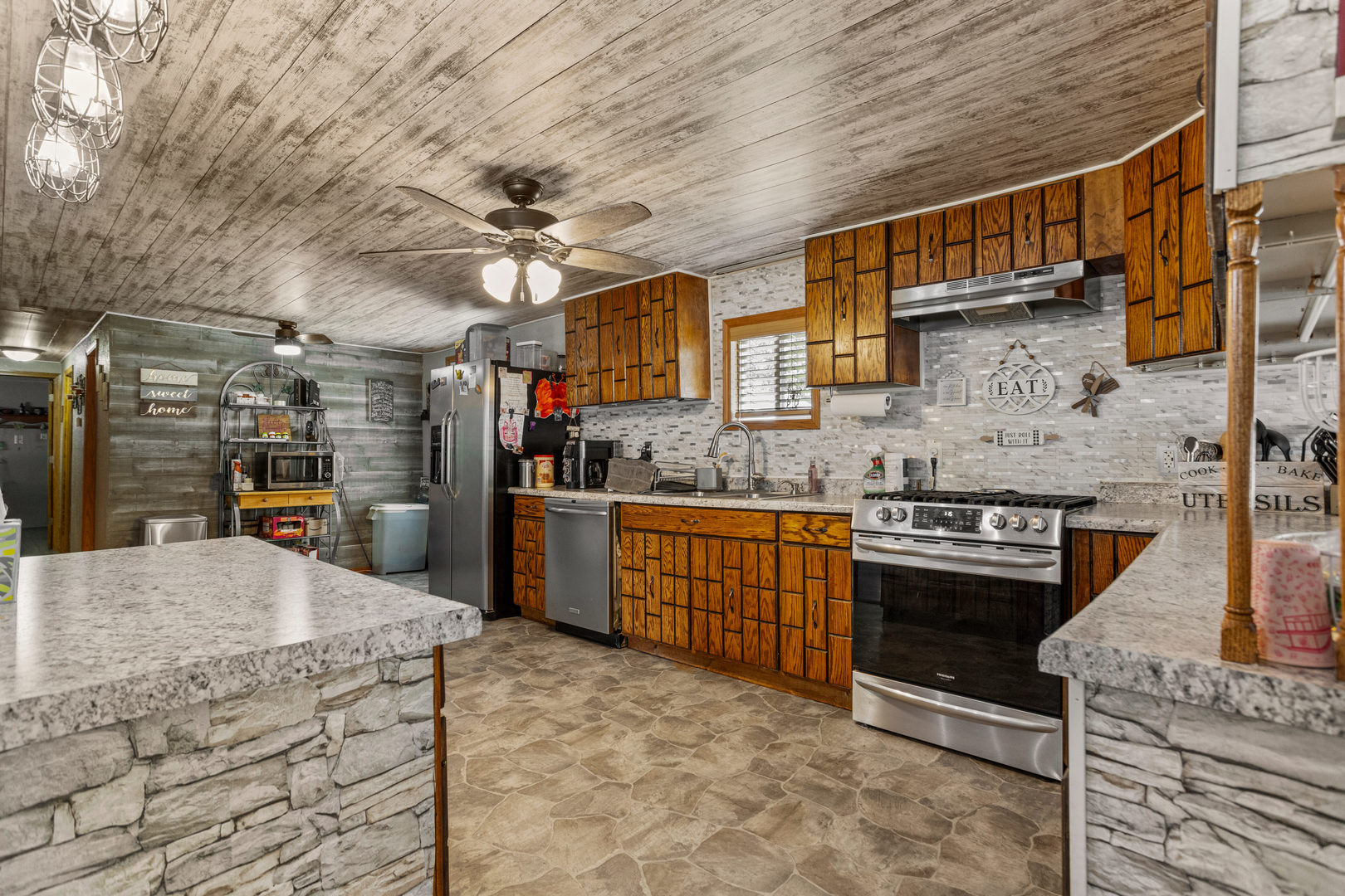 250 Troy Lane Decatur, IL 62526 - Photo 10 of 24 a kitchen with stainless steel appliances granite countertop a stove sink and cabinets