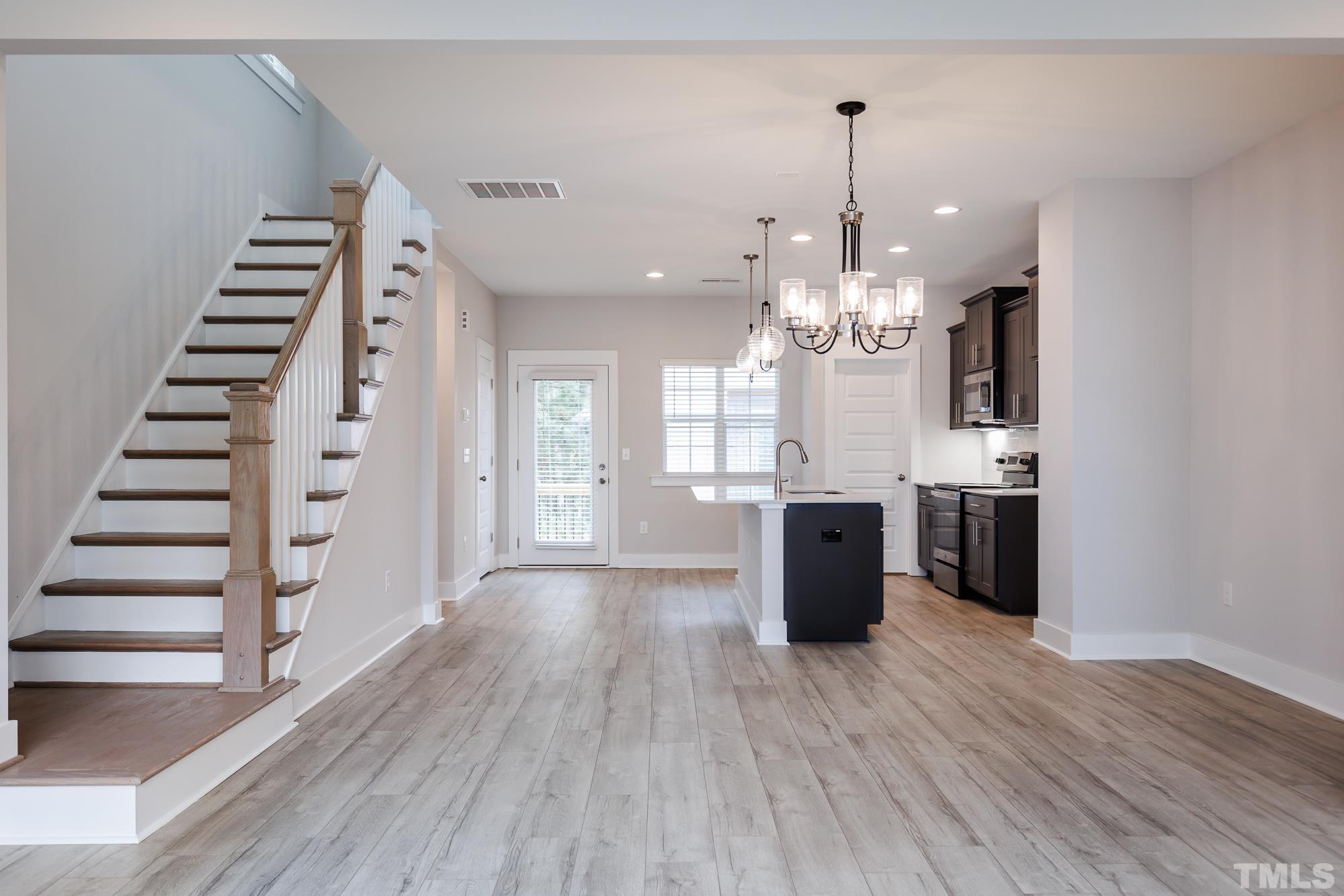 8510 Silsbee Drive Raleigh, NC 27613 - Photo 3 of 18 a view of a kitchen with wooden floor and electronic appliances
