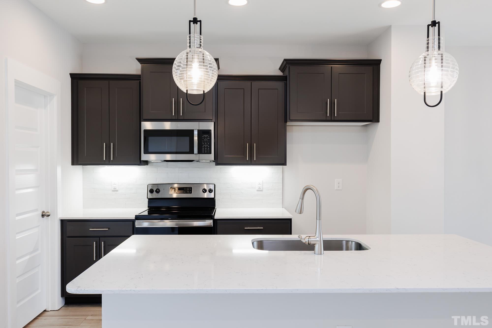 8510 Silsbee Drive Raleigh, NC 27613 - Photo 5 of 18 a kitchen with granite countertop a sink stainless steel appliances and cabinets