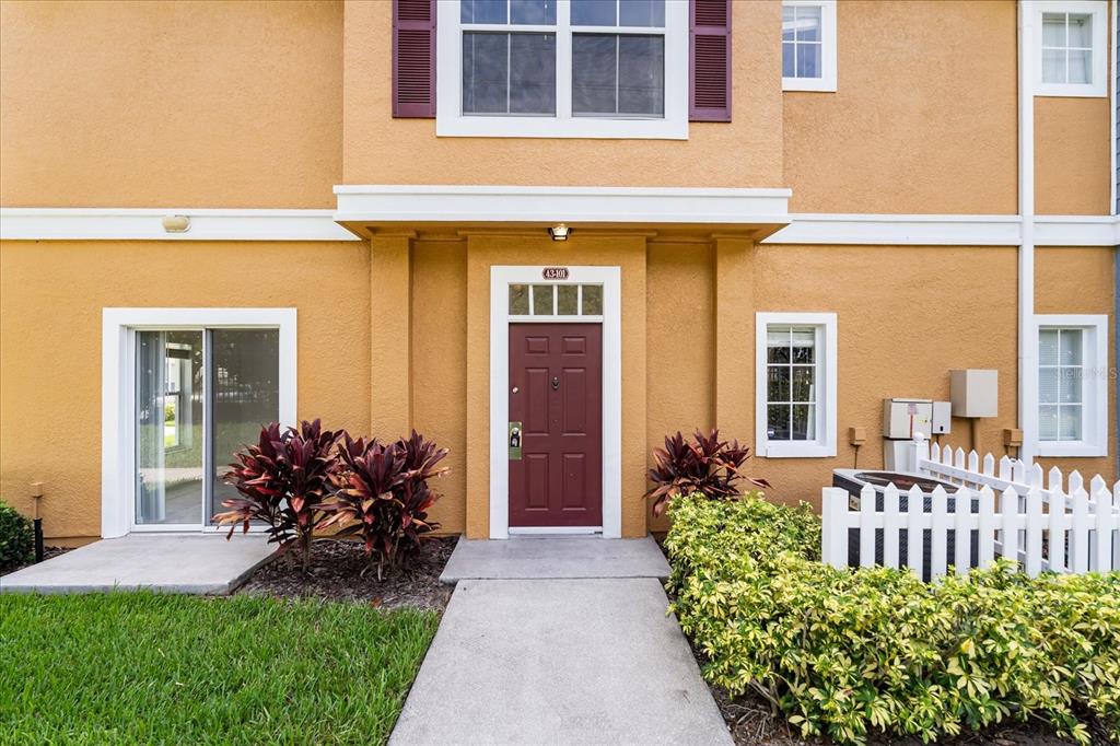 2280 San Vital Drive, Unit 101 Kissimmee, FL 34741 - Photo 1 of 1 a front view of a house having yard