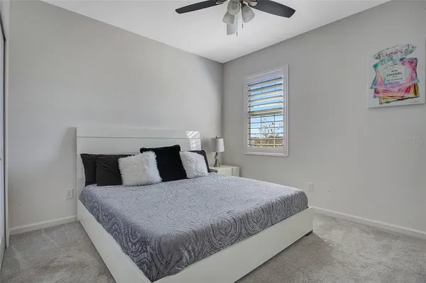 a bedroom with a bed and window