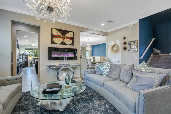 a living room with furniture and a chandelier