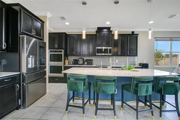 a kitchen with a sink cabinets and stainless steel appliances