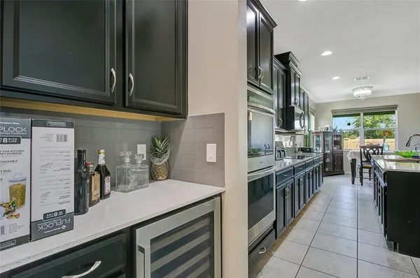 a view of a dining room with furniture and chandelier