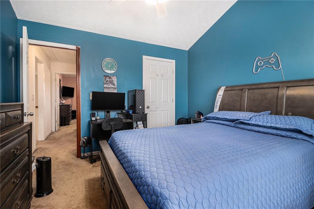 5610 Swanson Road Ellenwood, GA 30294 - Photo 18 of 28 a bedroom with a bed and a television