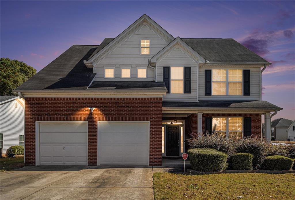 5610 Swanson Road Ellenwood, GA 30294 - Photo 26 of 28 a front view of a house with a yard