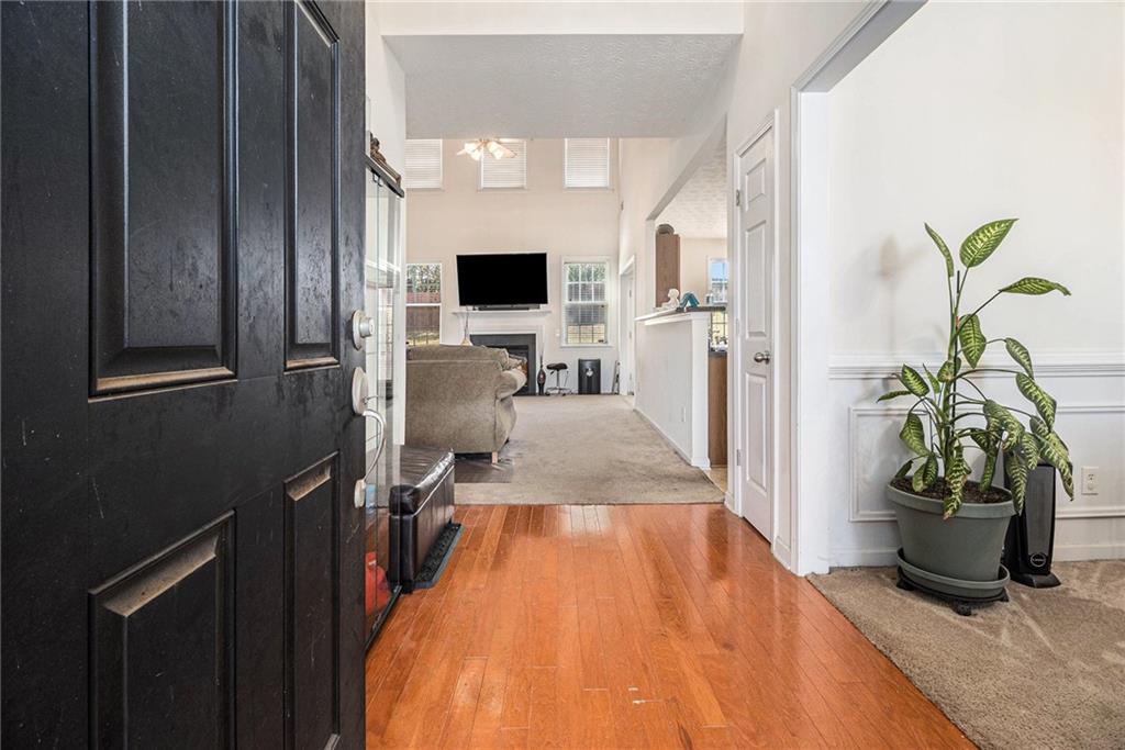 5610 Swanson Road Ellenwood, GA 30294 - Photo 3 of 28 a living room with furniture and a potted plant