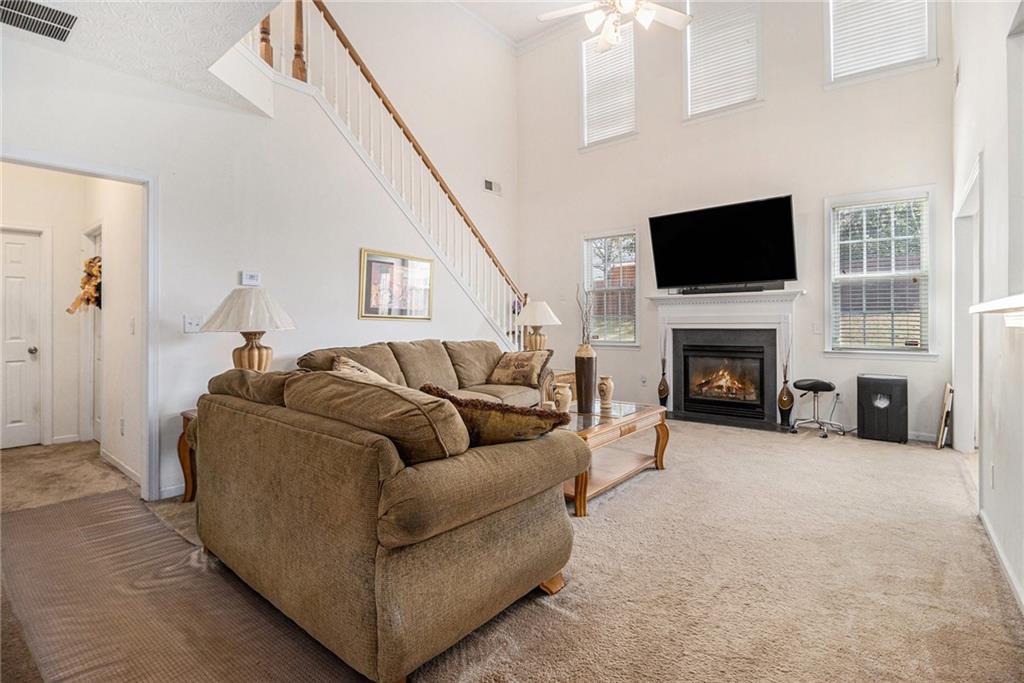 5610 Swanson Road Ellenwood, GA 30294 - Photo 4 of 28 a living room with furniture a flat screen tv and a fireplace