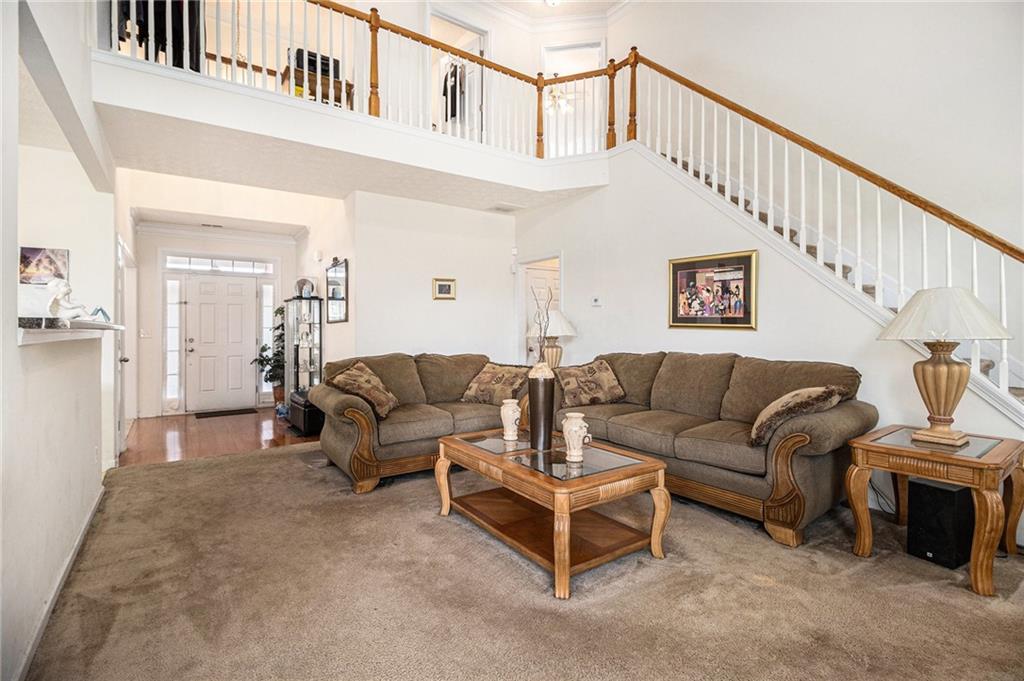 5610 Swanson Road Ellenwood, GA 30294 - Photo 5 of 28 a living room with furniture and a ceiling fan