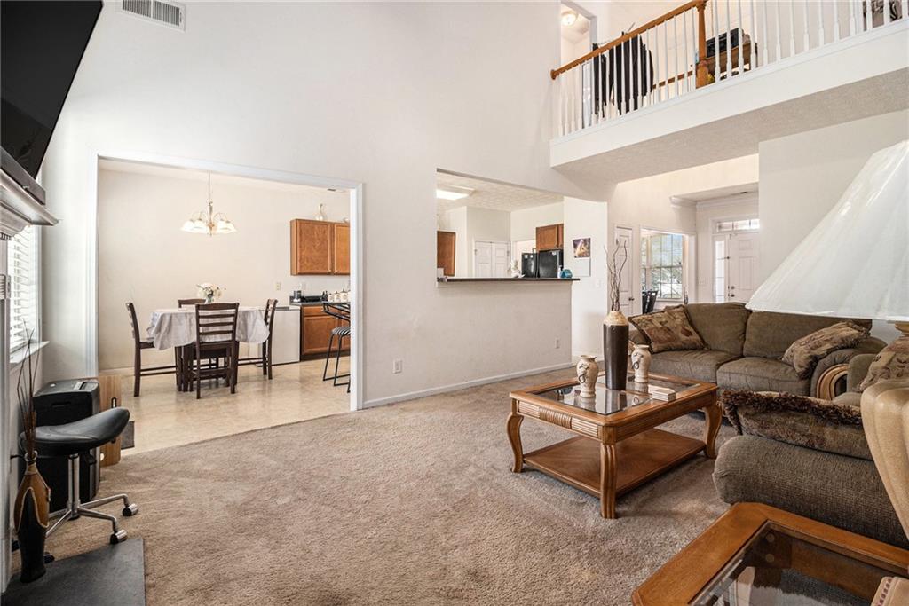 5610 Swanson Road Ellenwood, GA 30294 - Photo 6 of 28 a living room with furniture and a dining table with kitchen view