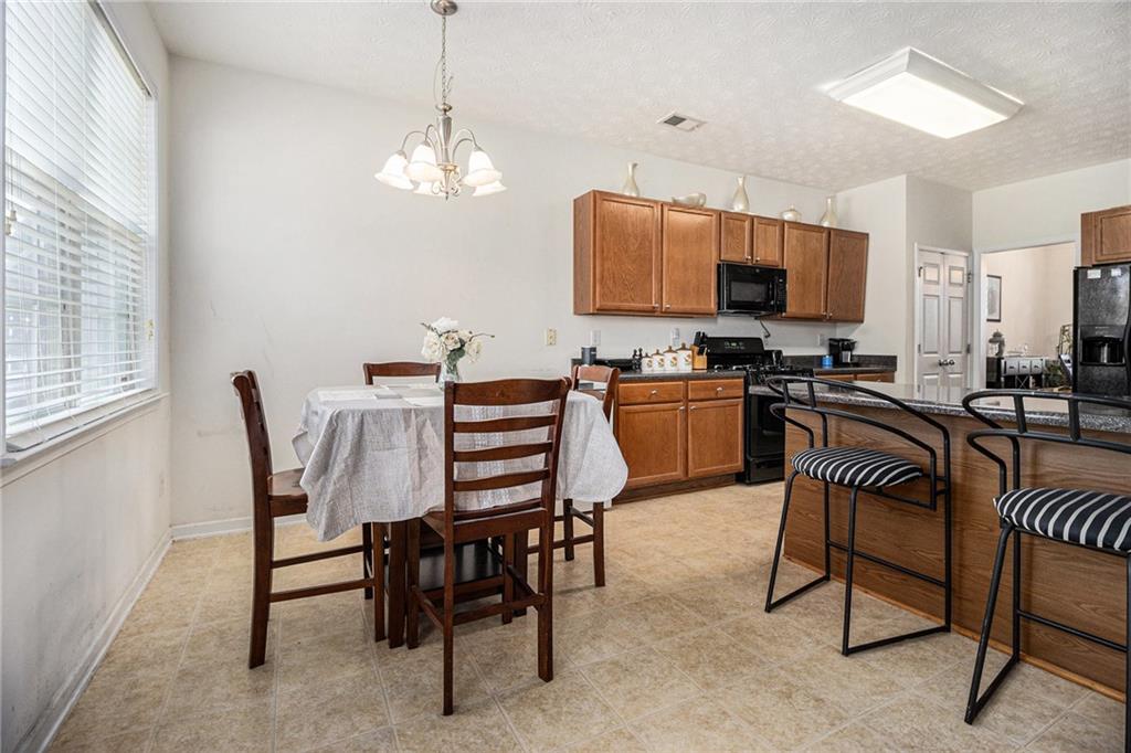 5610 Swanson Road Ellenwood, GA 30294 - Photo 7 of 28 a view of a dining room with furniture