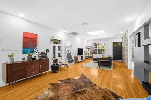 a living room with a table and a chair