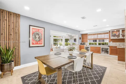 a living room with furniture a flat screen tv and kitchen view