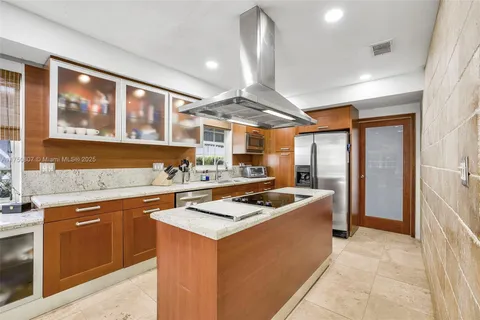 a kitchen with stainless steel appliances granite countertop a sink and a stove