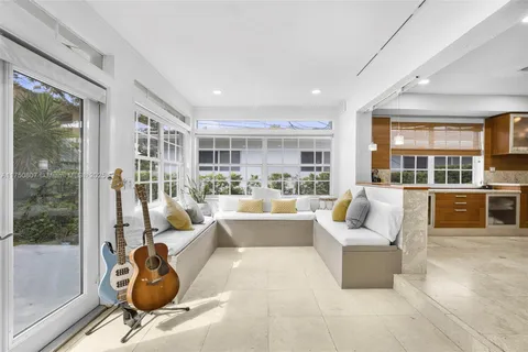 a living room with furniture and a view of kitchen