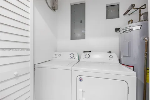 a view of a patio with plants and trees with wooden fence