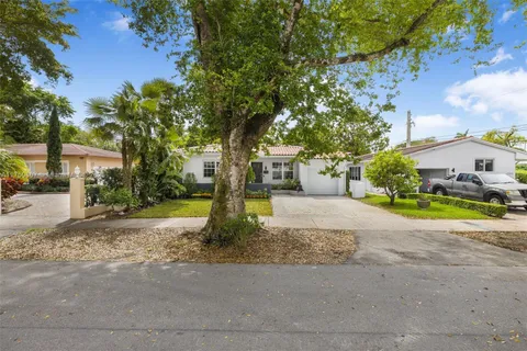 an aerial view of a house with a yard basket ball court and outdoor seating