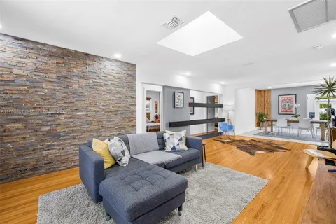 a living room with fireplace furniture and a wooden floor