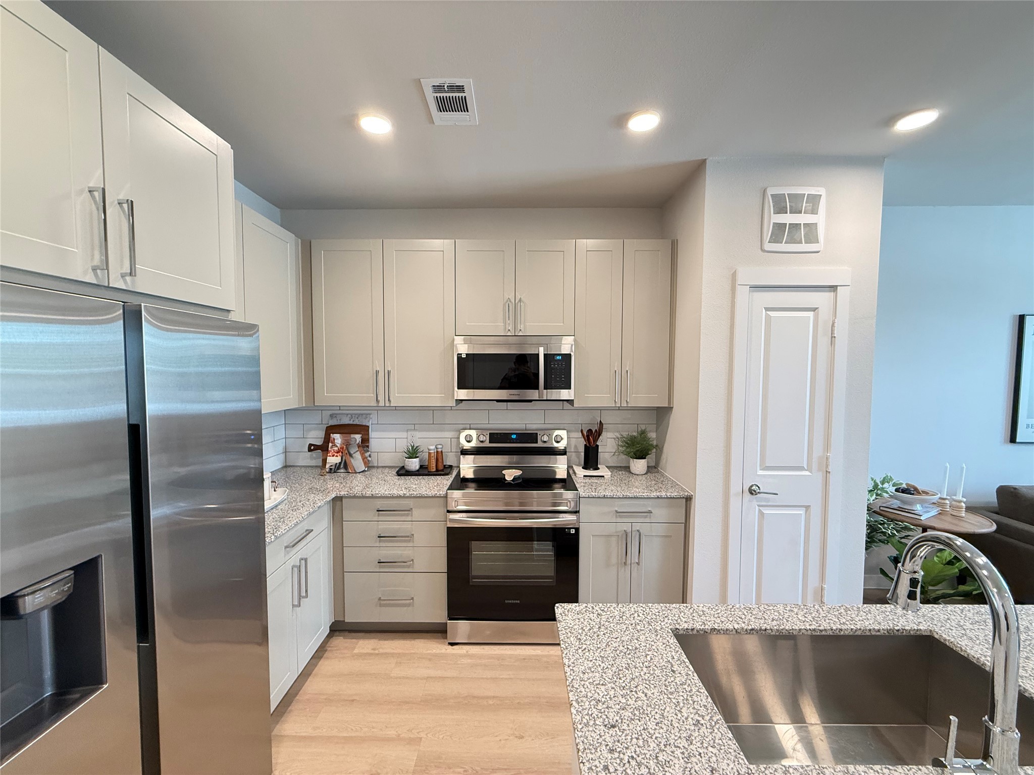 1610 Campbell Road, Unit A1 121 Houston, TX 77055 - Photo 4 of 11 a kitchen with stainless steel appliances granite countertop a stove a sink and a refrigerator