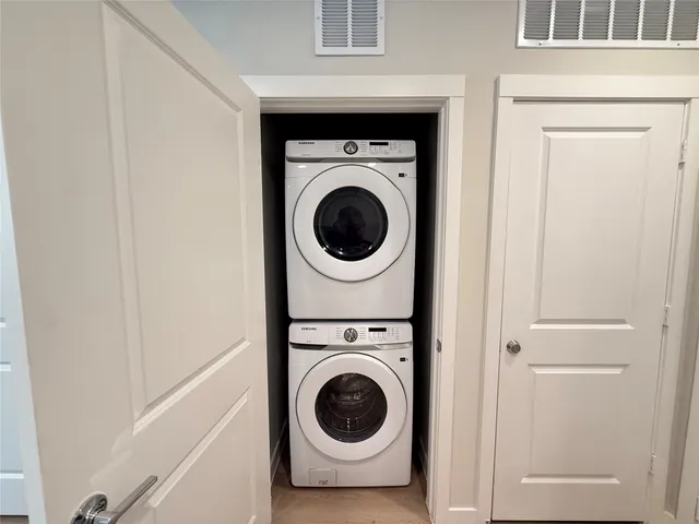 a kitchen with white cabinets and appliances