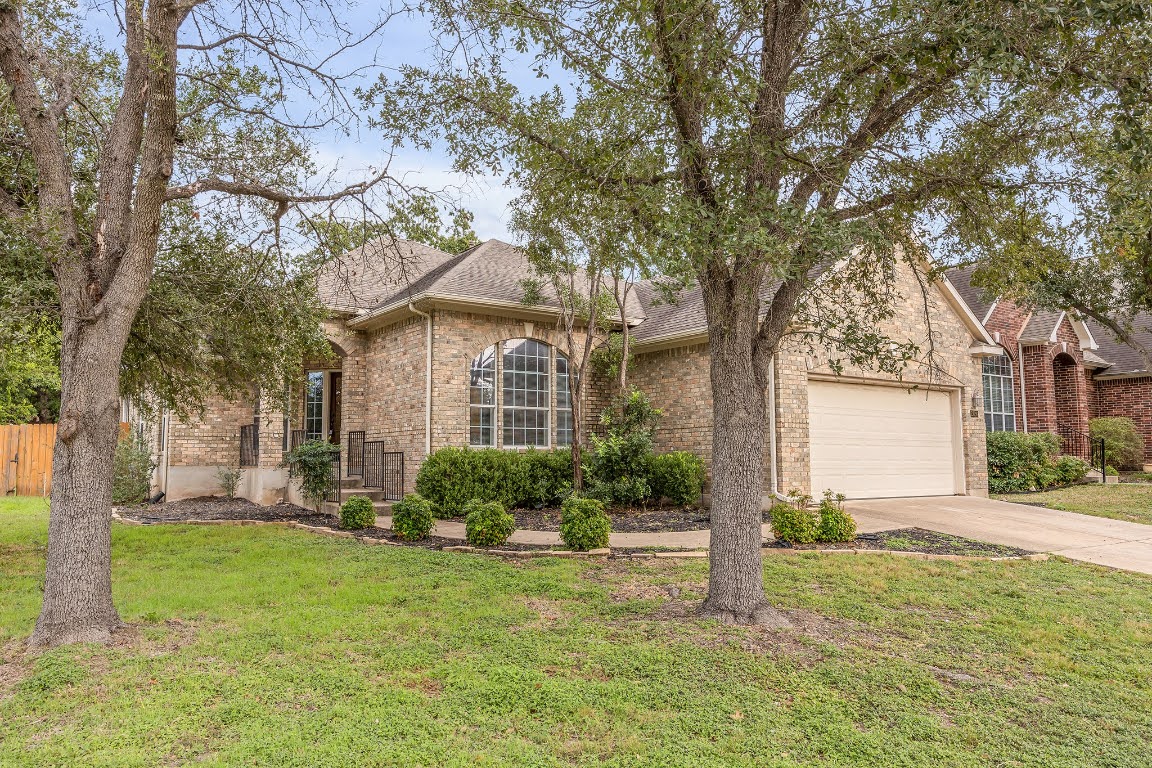 2726 Grimes Ranch Road Austin, TX 78732 - Photo 2 of 35 View of front facade with brick siding, driveway, and a shingled roof
