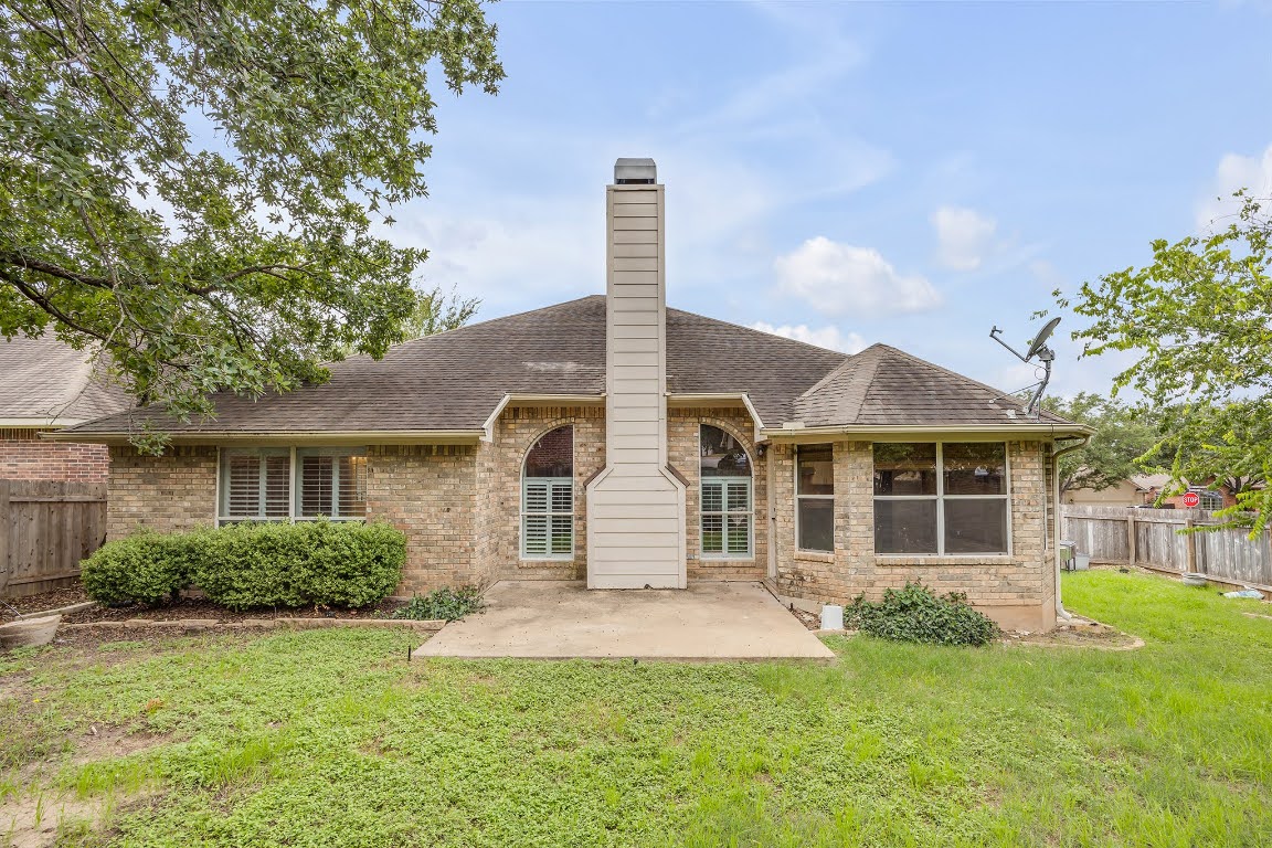2726 Grimes Ranch Road Austin, TX 78732 - Photo 34 of 35 Rear view of property featuring brick siding, roof with shingles, a patio, and a chimney