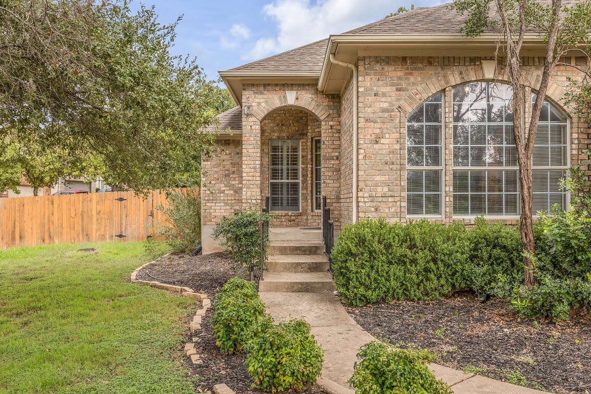 2726 Grimes Ranch Road Austin, TX 78732 - Photo 4 of 35 Entrance to property with a shingled roof and brick siding