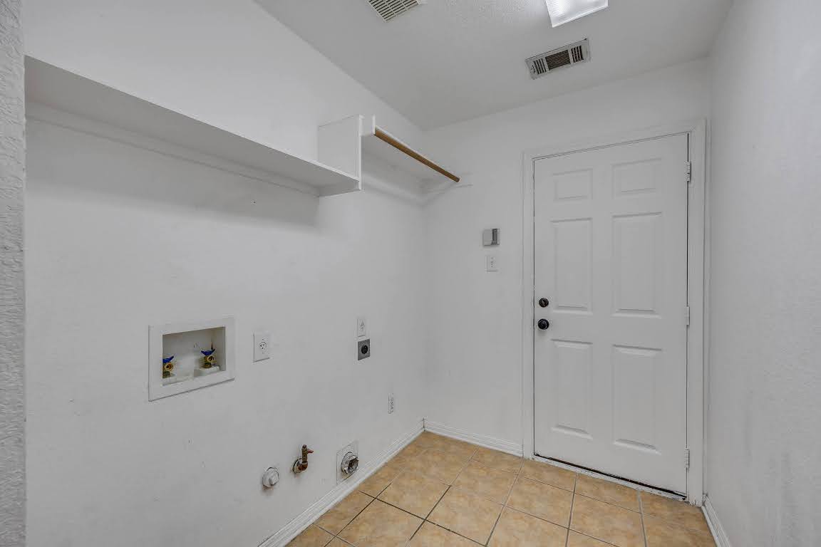 2726 Grimes Ranch Road Austin, TX 78732 - Photo 9 of 35 Laundry area featuring hookup for a gas dryer, hookup for a washing machine, light tile patterned floors, and electric dryer hookup