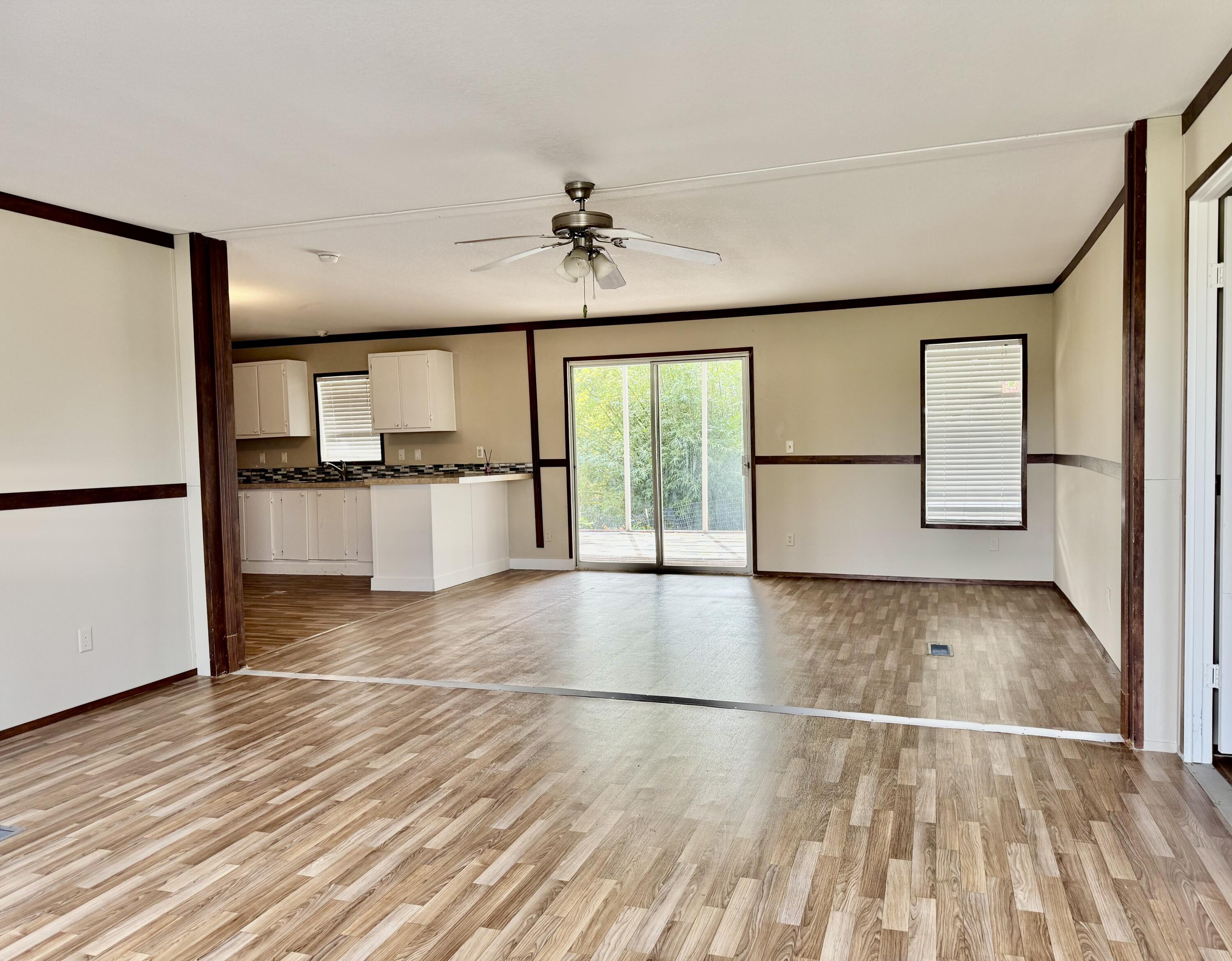 3200 Southeast 18th Court Okeechobee, FL 34974 - Photo 11 of 21 a view of a kitchen with wooden floor and a refrigerator