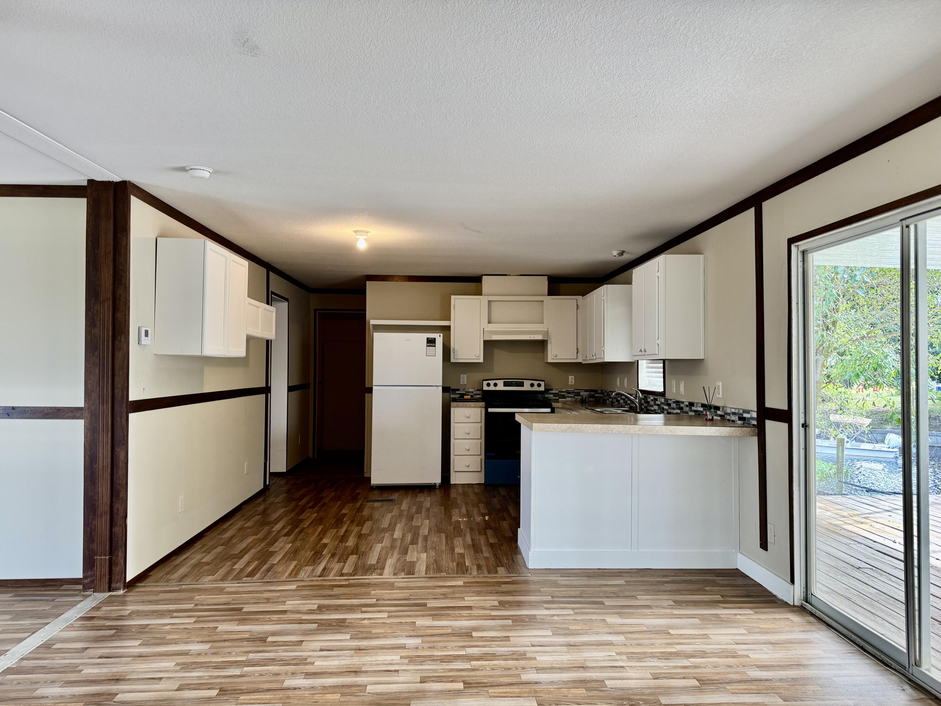 3200 Southeast 18th Court Okeechobee, FL 34974 - Photo 13 of 21 a kitchen with stainless steel appliances a refrigerator sink and cabinets