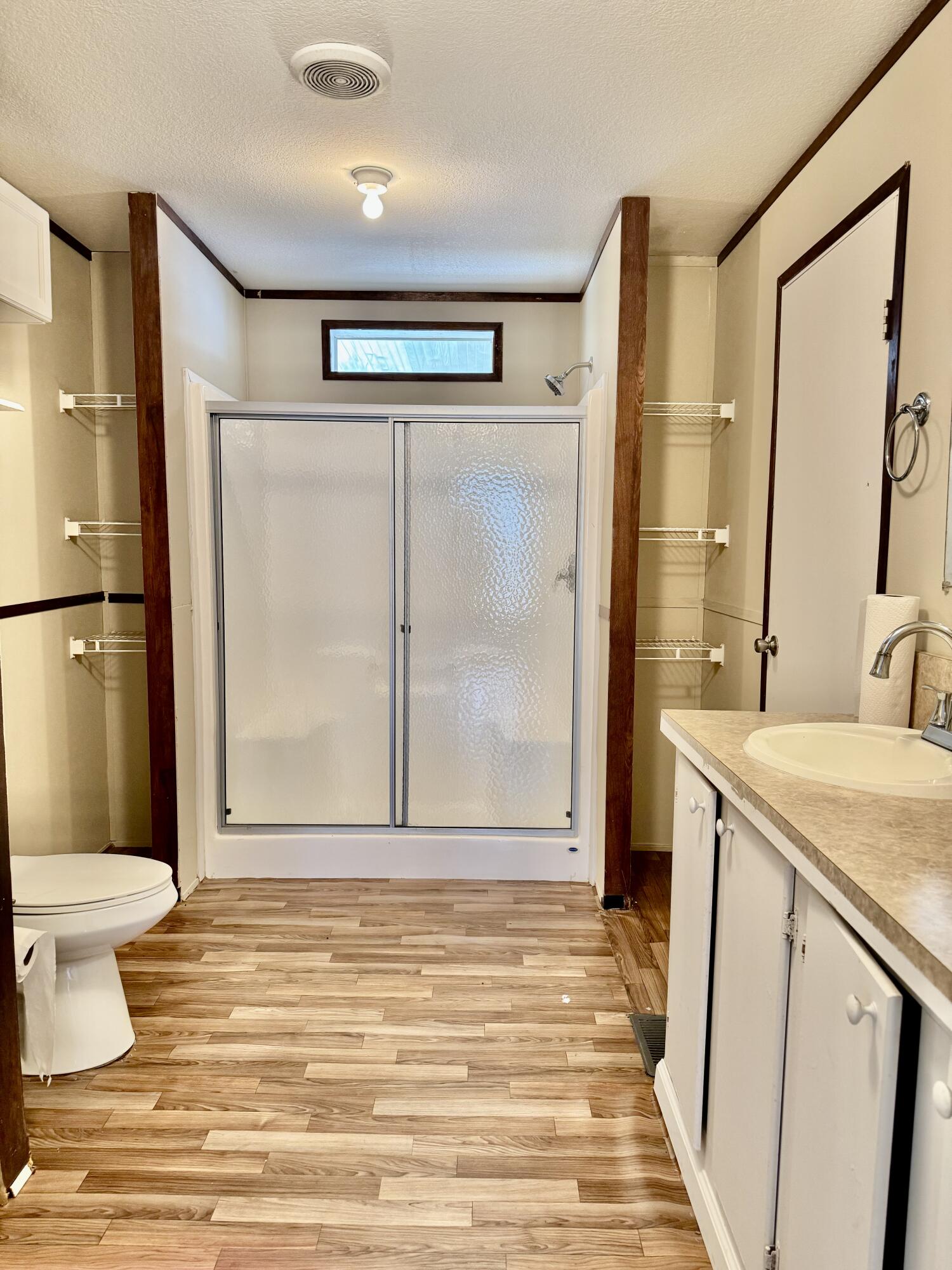 3200 Southeast 18th Court Okeechobee, FL 34974 - Photo 6 of 21 a bathroom with a granite countertop sink toilet and shower