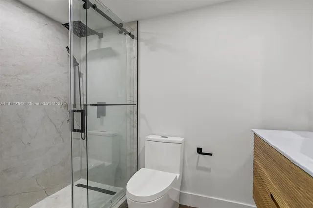 a bathroom with a shower toilet and sink
