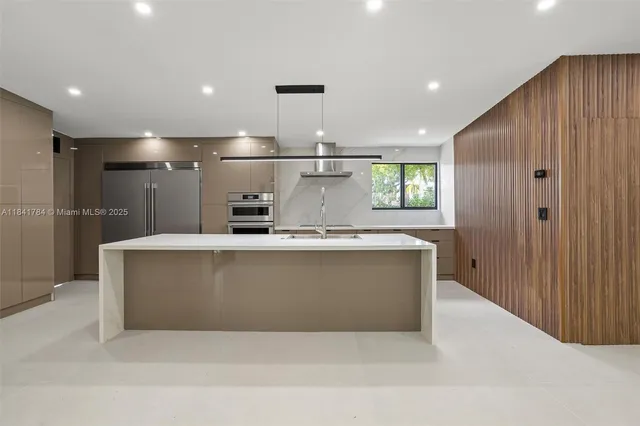 a view of kitchen with stainless steel appliances granite countertop counter top space