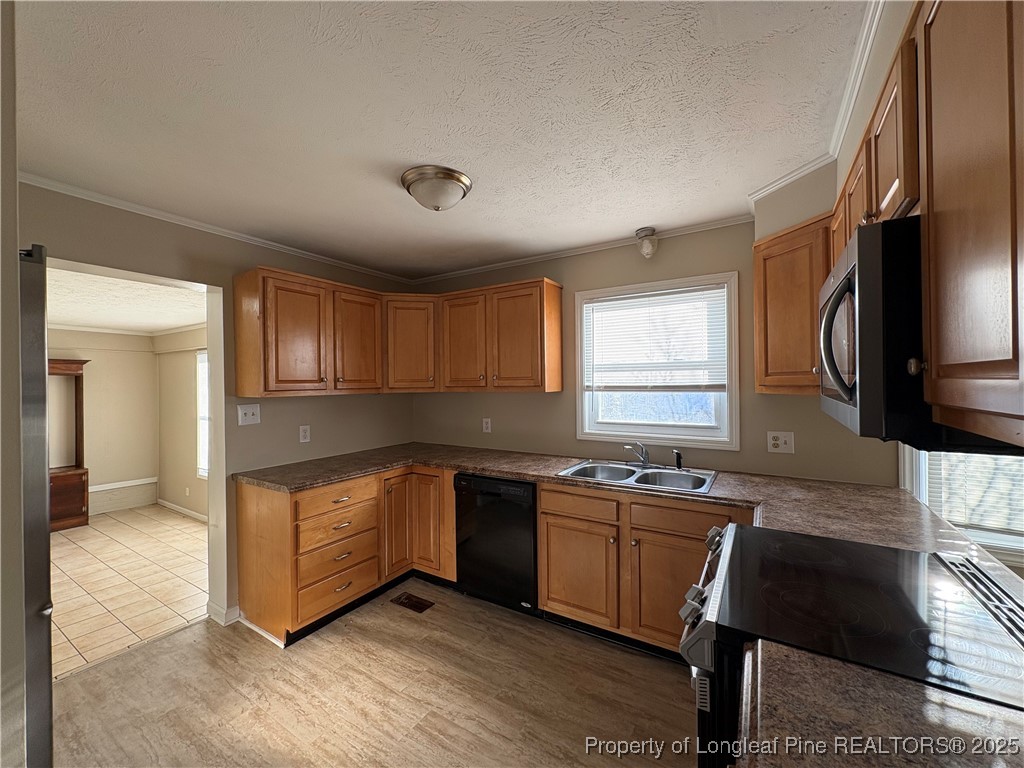 4639 Legion Road Hope Mills, NC 28348 - Photo 11 of 35 a kitchen with granite countertop a sink cabinets and wooden floor