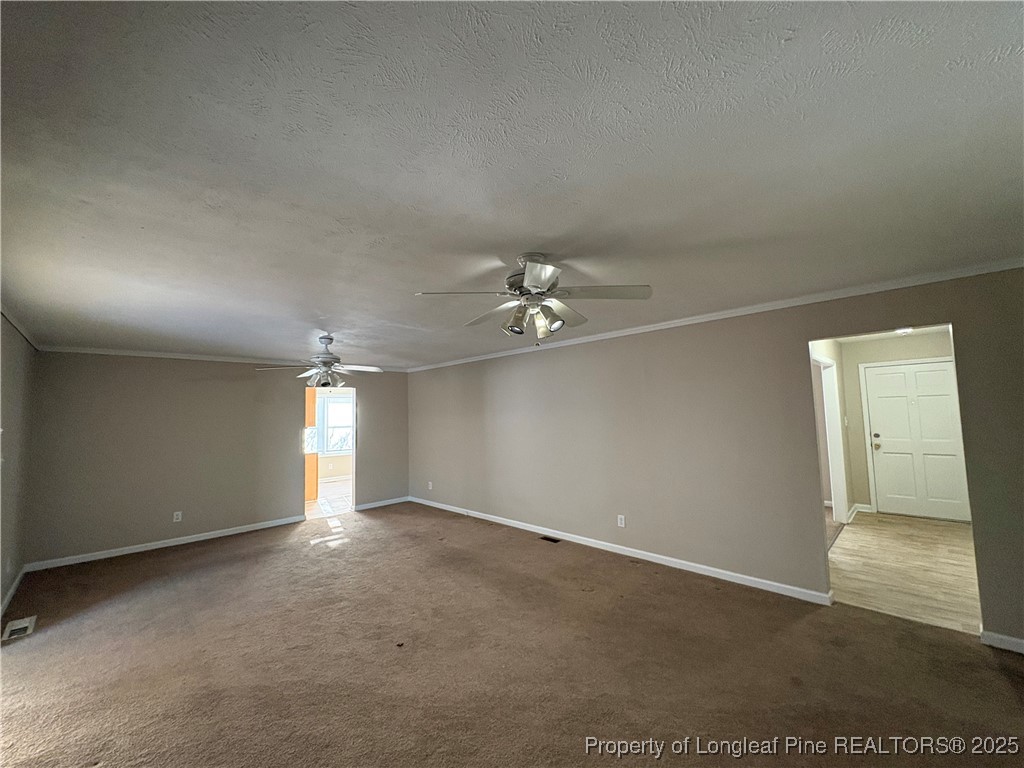 4639 Legion Road Hope Mills, NC 28348 - Photo 20 of 35 an empty room with chandelier fan and windows