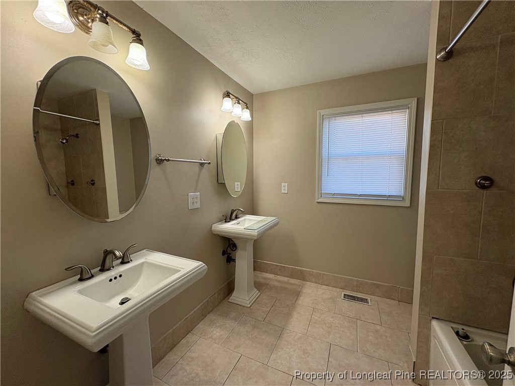4639 Legion Road Hope Mills, NC 28348 - Photo 27 of 35 a bathroom with a sink and a mirror