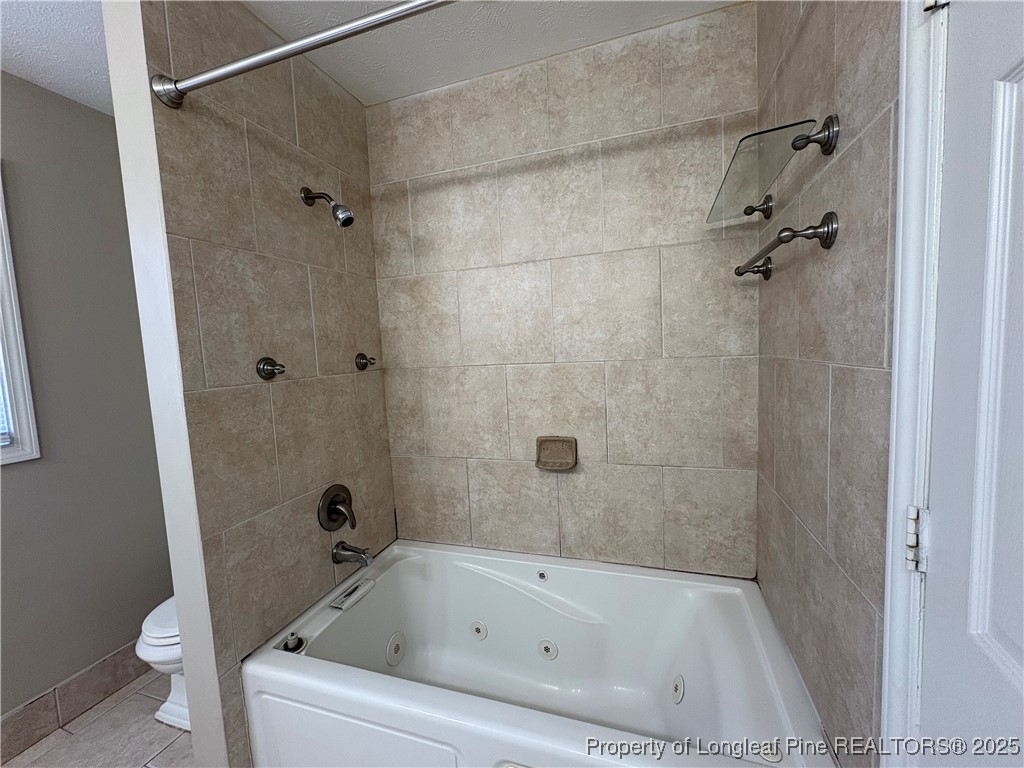 4639 Legion Road Hope Mills, NC 28348 - Photo 28 of 35 a bathroom with a bathtub