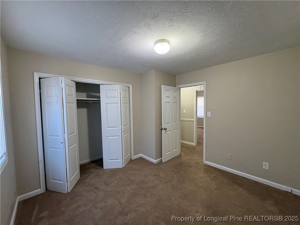 4639 Legion Road Hope Mills, NC 28348 - Photo 30 of 35 an empty room with closet and wooden floor