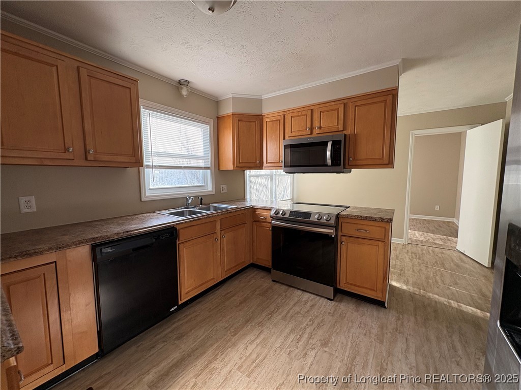 4639 Legion Road Hope Mills, NC 28348 - Photo 10 of 35 a kitchen with granite countertop a stove top oven sink and cabinets