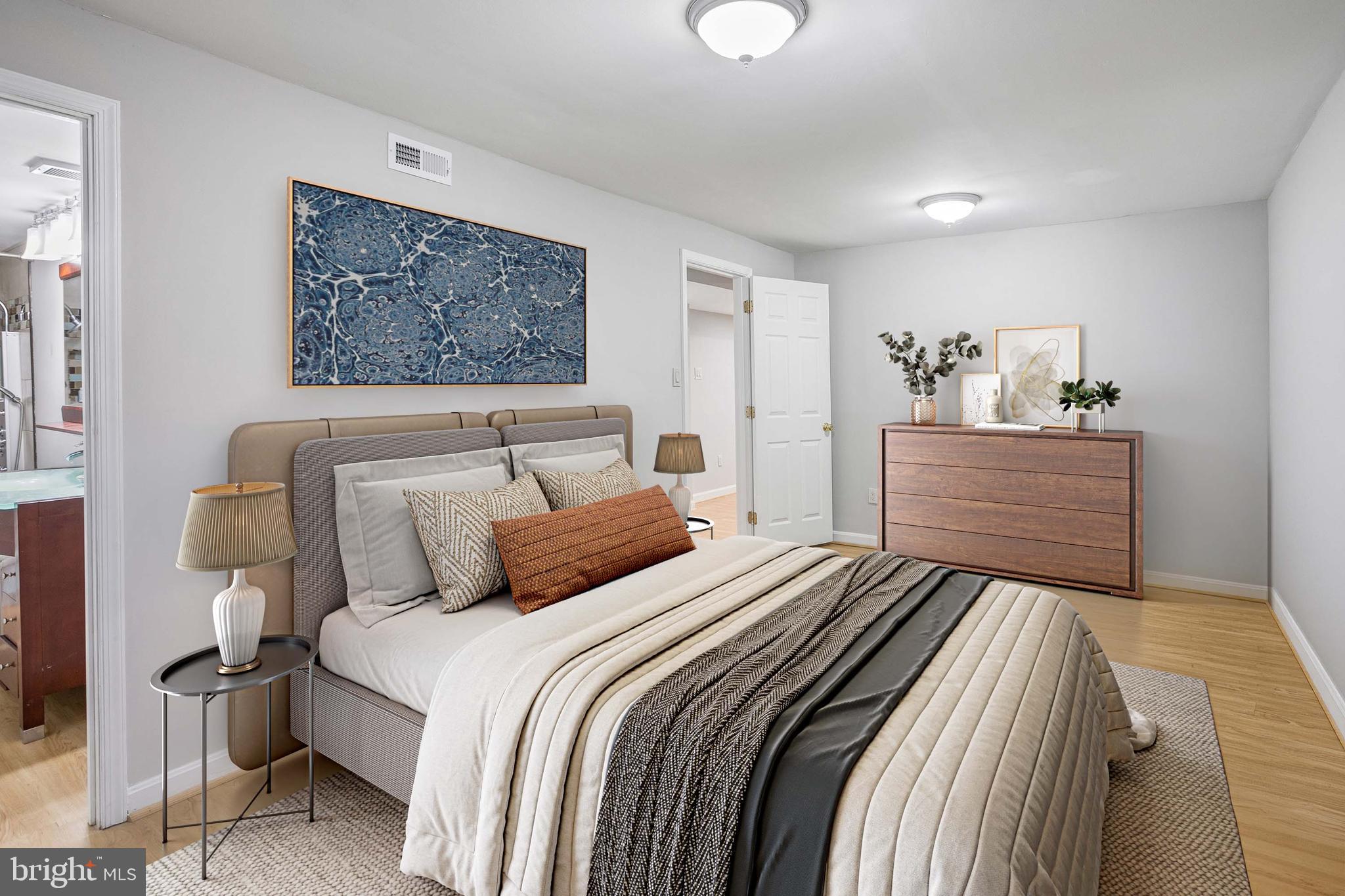 8217 Bayberry Ridge Road Fairfax Station, VA 22039 - Photo 16 of 35 a bedroom with a bed and painting on the wall