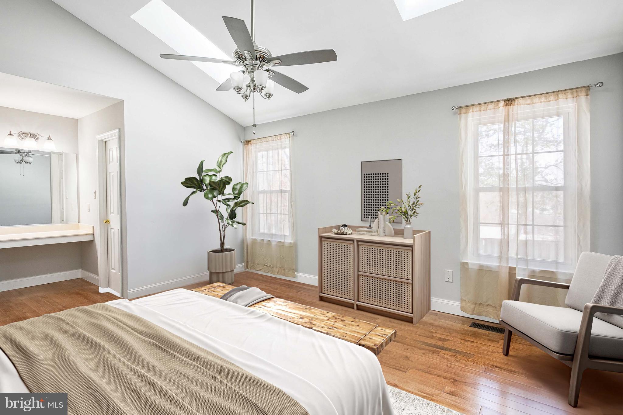 8217 Bayberry Ridge Road Fairfax Station, VA 22039 - Photo 18 of 35 a bedroom with a bed and a chandelier
