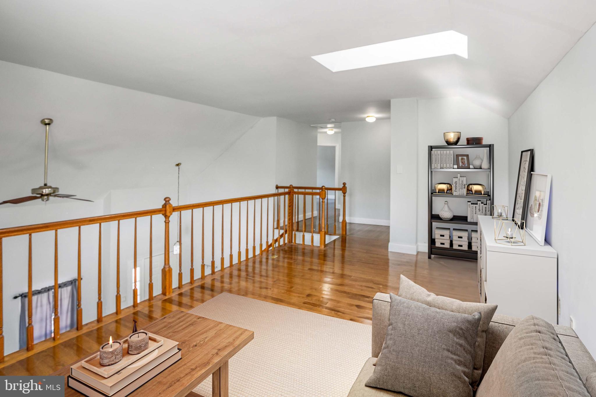 8217 Bayberry Ridge Road Fairfax Station, VA 22039 - Photo 25 of 35 a living room with furniture and a book shelf