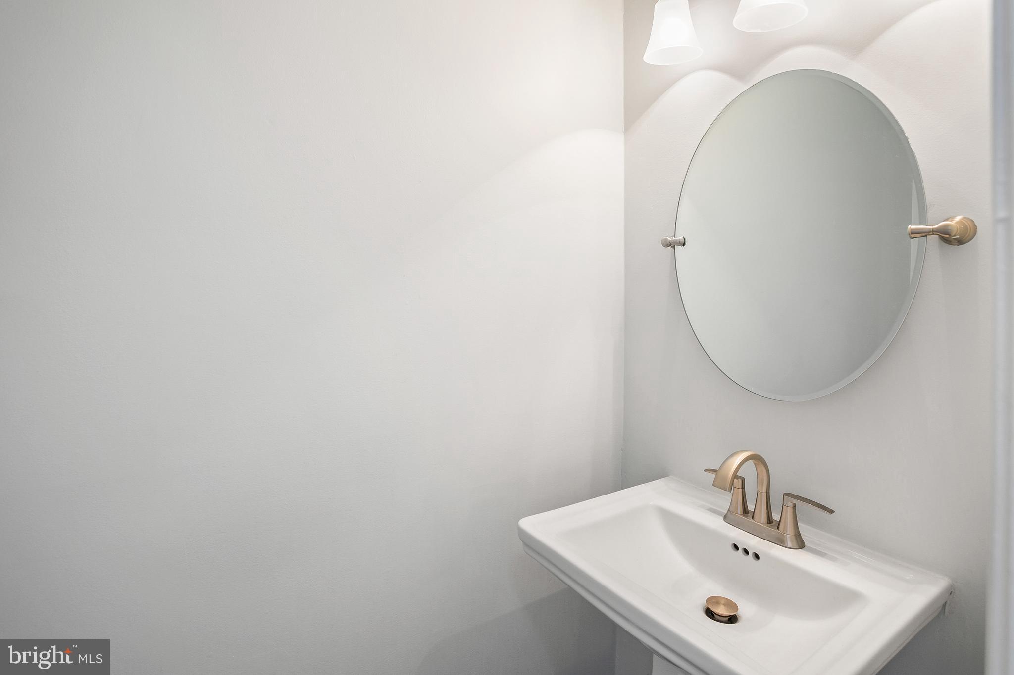 8217 Bayberry Ridge Road Fairfax Station, VA 22039 - Photo 26 of 35 a bathroom with a sink and a mirror