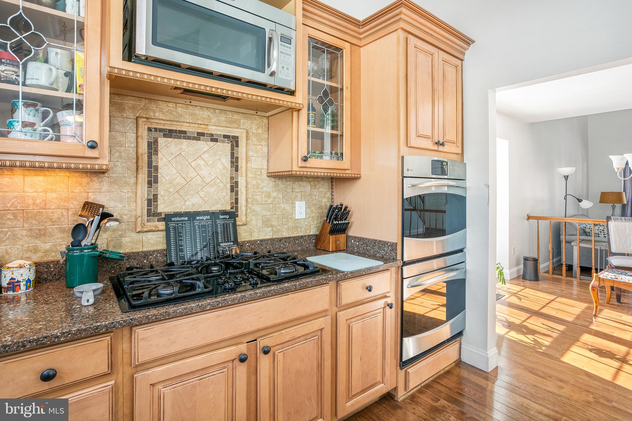 8217 Bayberry Ridge Road Fairfax Station, VA 22039 - Photo 6 of 35 a kitchen with stainless steel appliances granite countertop a stove a sink and white cabinets